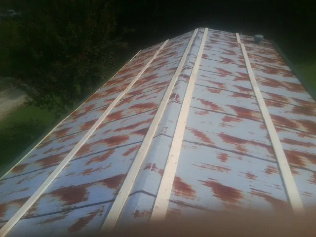 Rusted metal roof panels with new wood purlins before replacement — Storm Damage Roof Repair in Ruskin by Roofing Brothers